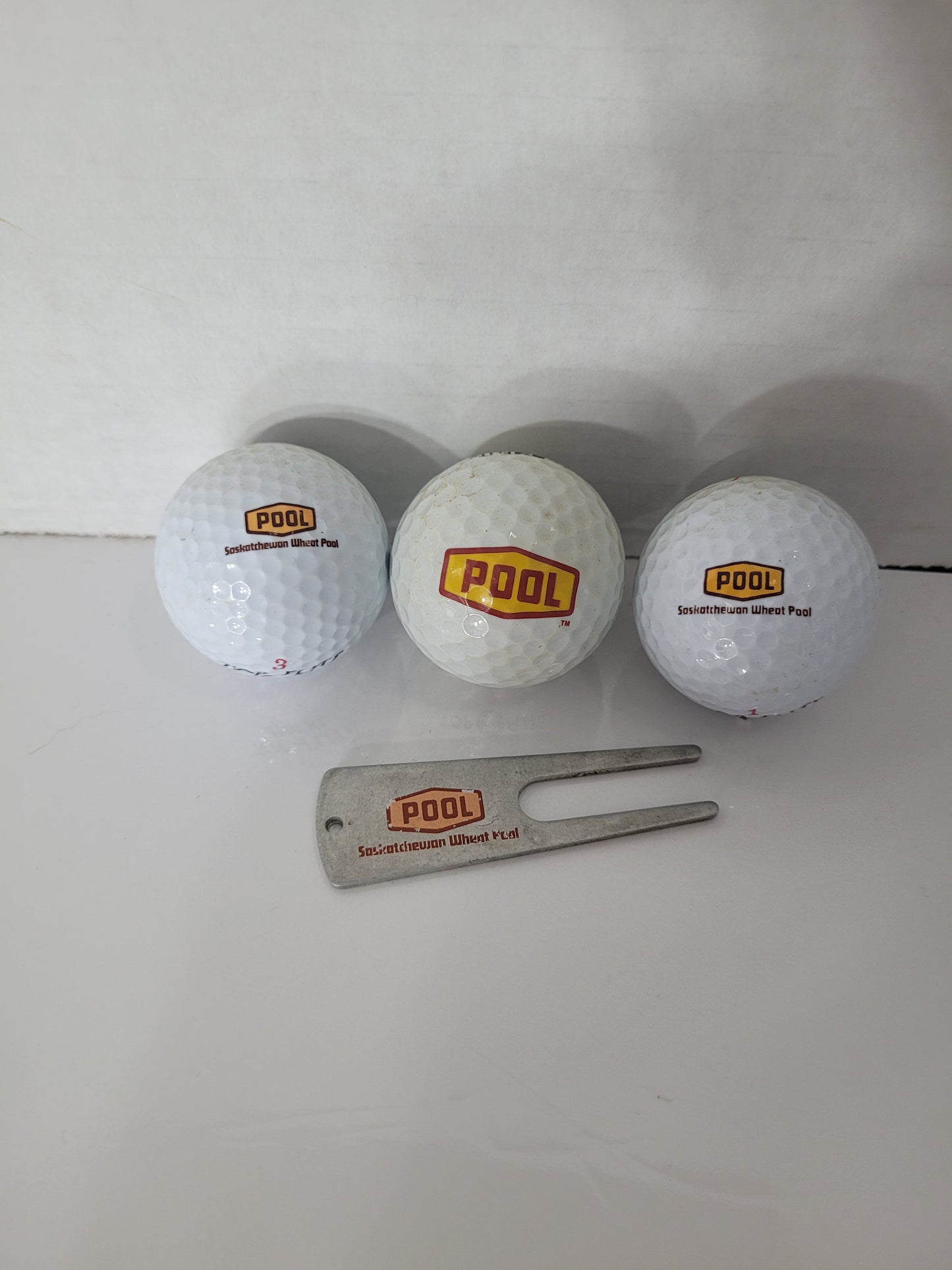Vintage Saskatchewan Wheat Pool Golf Balls & Divot Repair Tool – 4-Piece Promotional Set