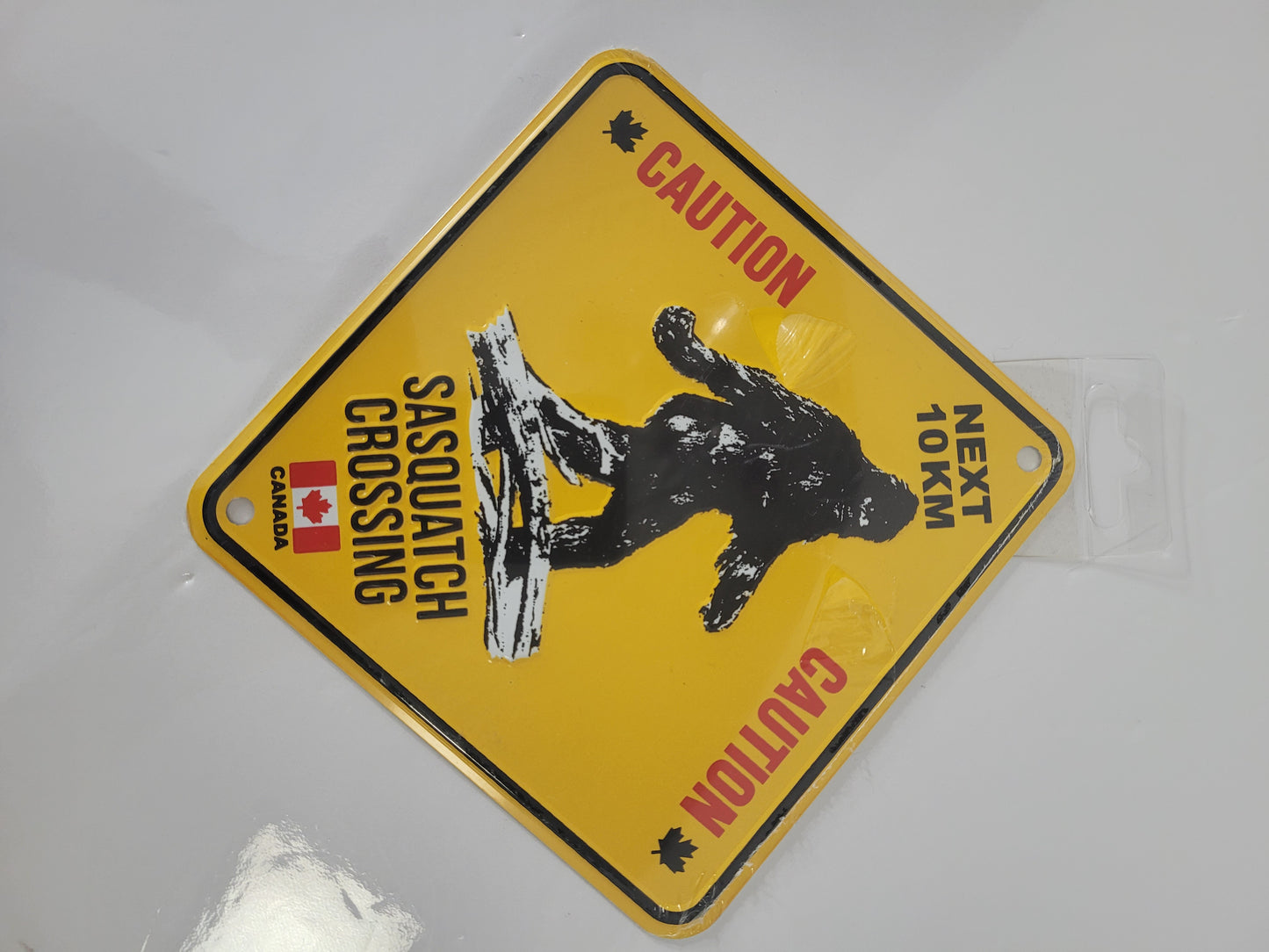 Sasquatch Crossing Canada Embossed Metal Sign – 8" x 8" – Snowcap Trading