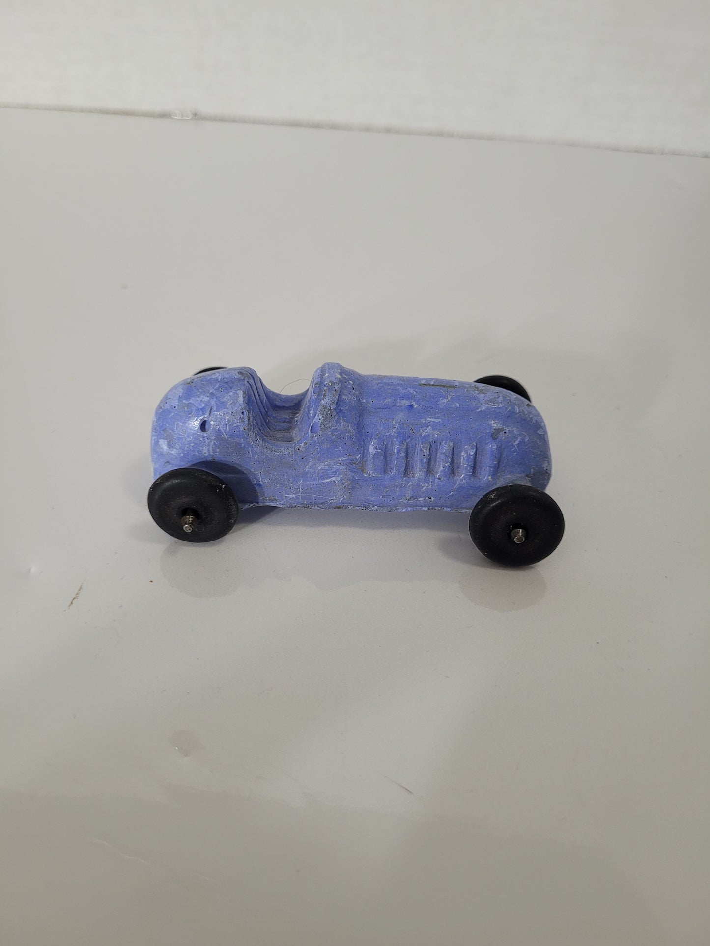Vintage Blue Chalkware Race Car Toy with Black Wheels – 3" x 1.5"