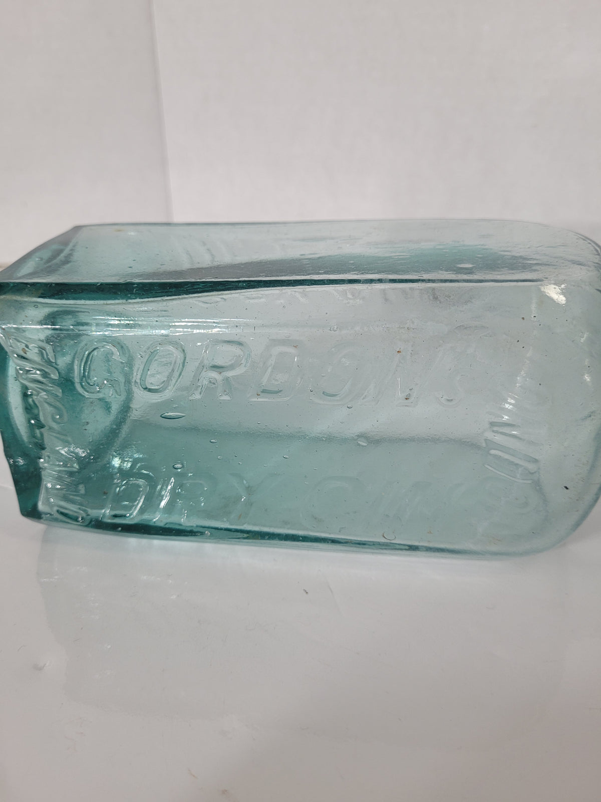 Antique Gordon’s Dry Gin Aqua Glass Bottle – London England – Embossed Boar Mark – c.1910s–1920s