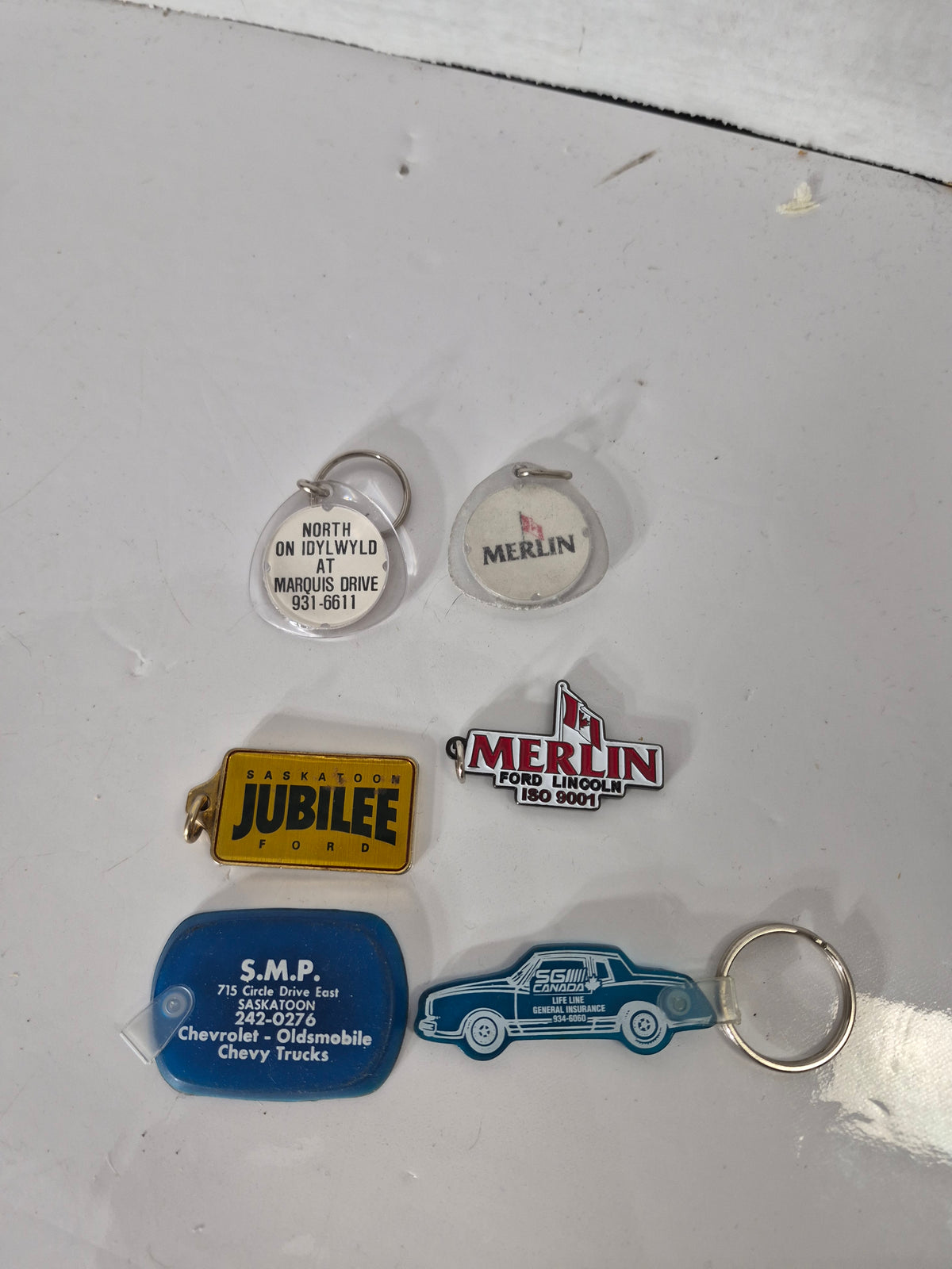 Vintage Saskatoon Car Dealership Keychain Lot of 6 – Merlin Ford, Jubilee Ford, SMP Chevrolet & SGI Canada