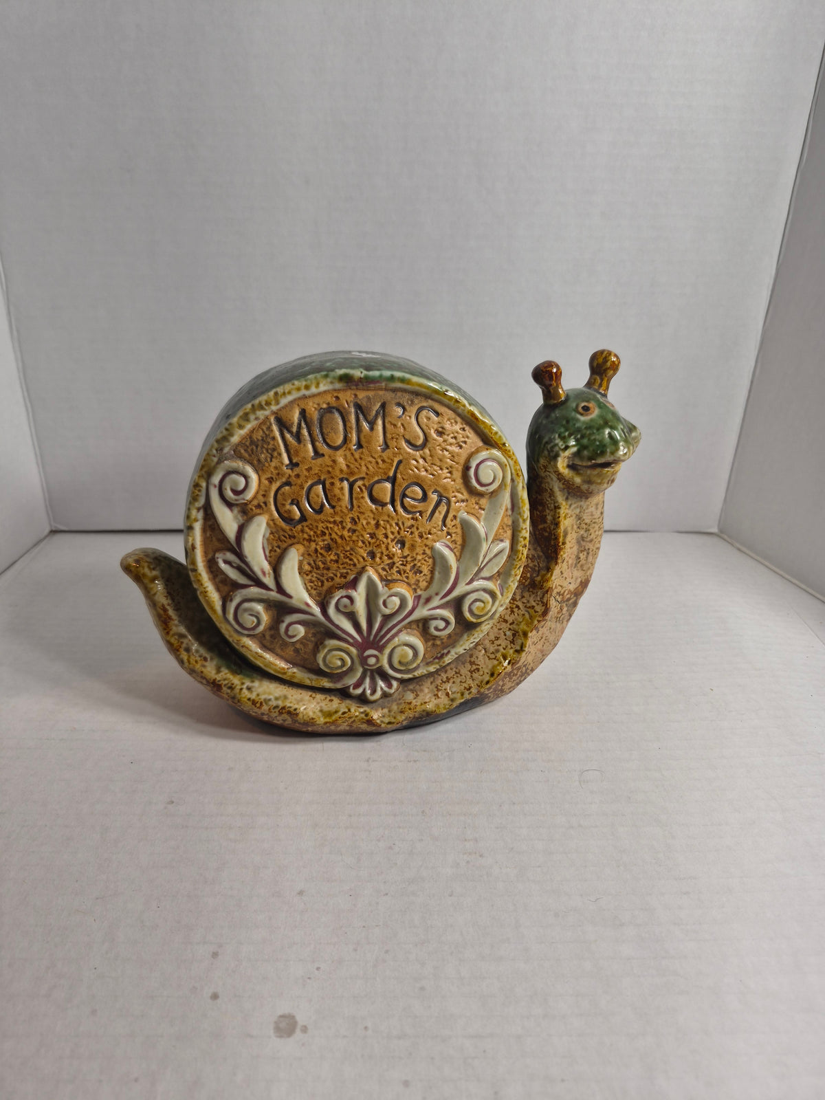 Ceramic Snail Garden Ornament – Mom's Garden Sign – Double-Sided with Spiral Shell – Green and Tan Glaze – 9 x 7 Inches